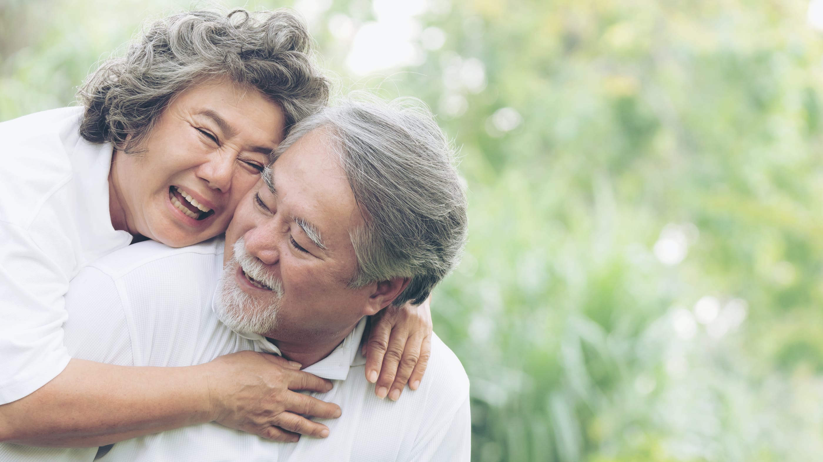 Happy love Elderly couple smile face , Senior couple old man and senior woman relaxing hug in a forest