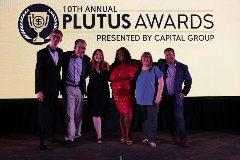 On stage at the Plutus Awards