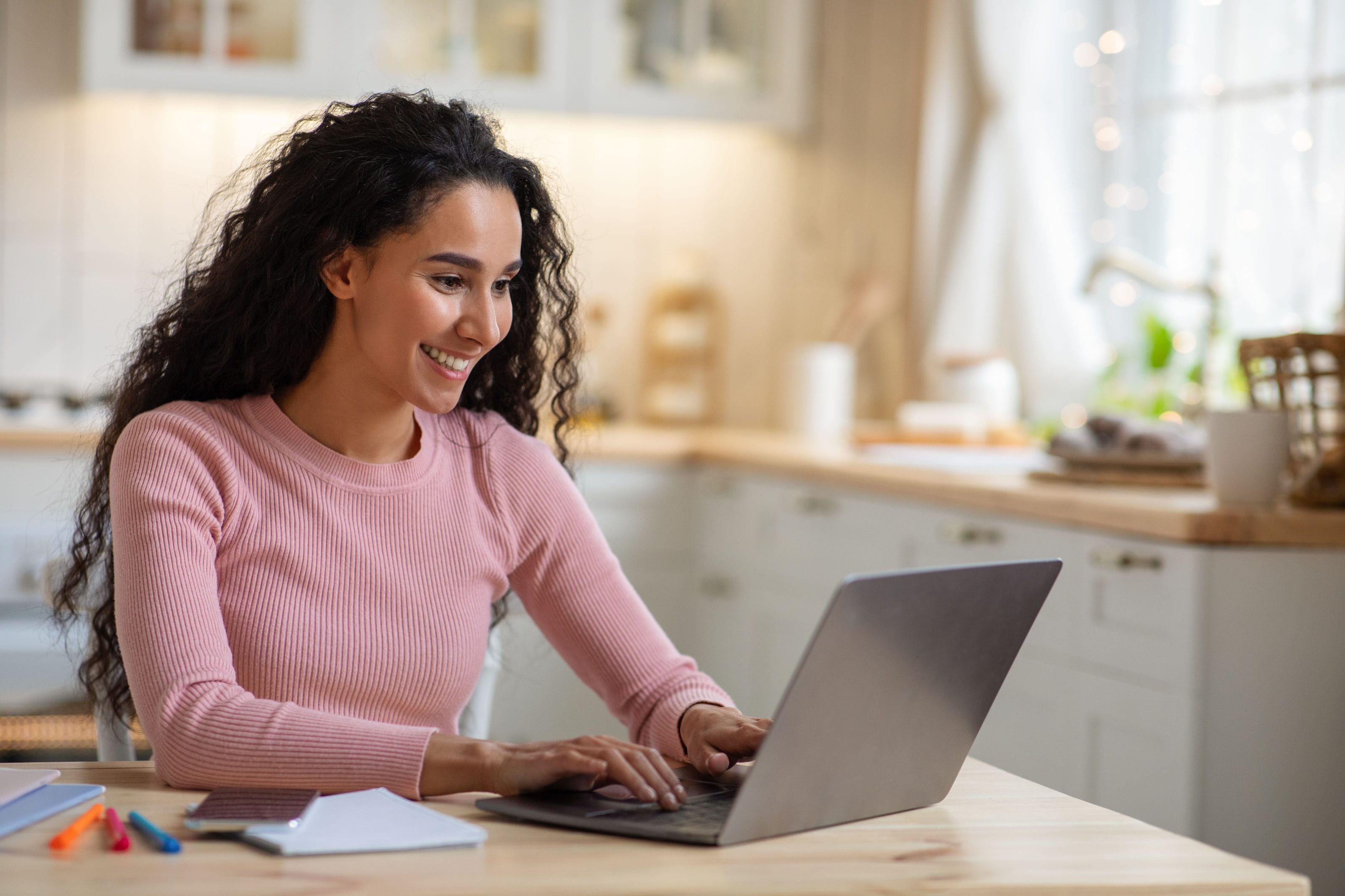woman at laptop registering a trademark for her blog